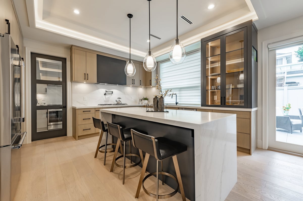 Beautiful renovated modern kitchen with white countertops and wooden cabinets