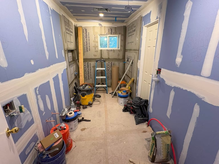 Babylon, New York, USA - 25 May 2025: Construction tools and materials clutter a room awaiting final installation and design.